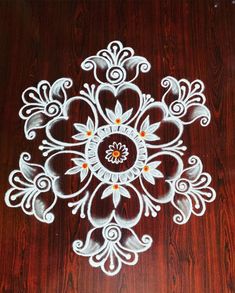 a wooden table topped with an intricately designed white doily on top of it