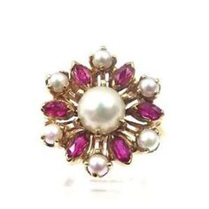 Hi, Here we have a beautiful 14k Yellow Gold Vintage Women's Flower Shape Cocktail Ring With Pearls & Ruby July BirthStones. Total weight: 6.6g. Measurements: 19.25 x 19.25 mm. SIZABLE. The perfect gift for your loved one. Comes with a free gift box. The center pearl size 6.5 mm. The smaller pearls are 3mm. Item is vintage and will show normal wear, but in great shape. Buy with confidence, we only sell top quality items. Thanks for looking and have a great day. Elegant White Ruby Ring In 14k Gold, Elegant 14k Gold White Ruby Ring, Yellow Gold Multi-stone Round Pearl Ring, Yellow Gold Multi-stone Pearl Ring, White 14k Gold Cluster Jewelry, White Ruby Ring In 14k Gold, Heirloom Ruby Cluster Jewelry, Elegant White Ruby Ring With Multi-stones, Yellow Gold Cluster Jewelry With Accent Stones