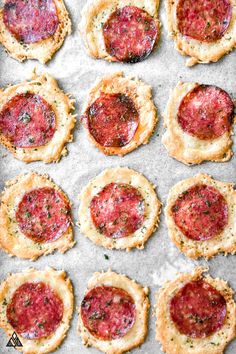 mini pizzas are arranged on a baking sheet to be baked in the oven for dinner