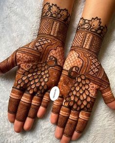 two hands with henna designs on them