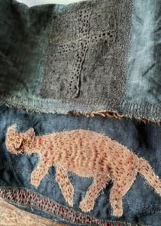 an embroidered animal is on the back of a piece of clothing that has been stitched together