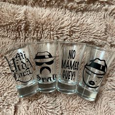 three shot glasses sitting on top of a blanket