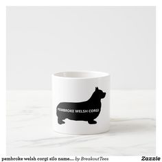 a white coffee mug with a black silhouette of a dog