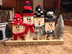 a group of snowmen sitting on top of a kitchen counter