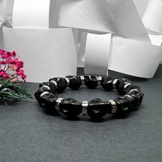 Get ready to rock and roll with this Black Skull Beaded Bracelet featuring Metallic Silver Steel Tone Disk/Round Beads. The perfect accessory for cool guys who love to add an edge to their style. Whether it's for a casual autumn look, a spooky Halloween vibe, or just everyday fashion, this adjustable elastic wristband is a must-have! Embrace the Mexican Dia de Muertos spirit with this Calacamania™ jewelry piece. • GET IT FAST!Get it fast! Ready to ship on 1 to 3 business days. • ORDER NOW!Limited Quantities / Limited Edition. • FREE GIFT BOX INCLUDED!Get a Free Craft Gift Box with any order* Thank you for stopping by!_______________________ *Colors/Designs might slightly vary from actual. Autumn Look, Black Skull, Wristband Bracelet, Black Skulls, Beaded Skull, Fall Looks, Dia De Muertos, Spooky Halloween, Craft Gifts