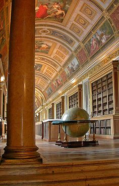 an old library with bookshelves and a globe