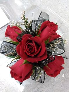 a bouquet of red roses sitting on top of a table