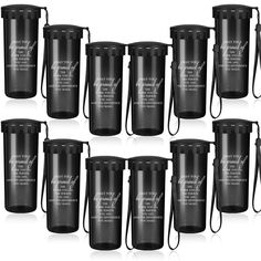 six black travel mugs with white writing on them