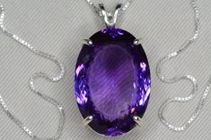 "This amethyst necklace features a genuine earth mined amethyst with a fabulous purple color. The necklace and pendant are made of solid sterling silver. This item is brand new and has been certified by the Canadian Federal Gemological Laboratory of Canada. The certificate will be included and describes the amethyst as follows:  \"Shape and cut: Oval Weight: 53.43 ct Species: Natural Quartz Variety: Amethyst Colour: Purple Transparency: Transparent Luster: Vitreous Refractive Index: 1.55 - 1.56 Identifying characteristics: Internal M.S.R.P: $3,740.00 CAD\" Please feel free to browse my shop for hundreds of additional pieces of certified gemstone jewelry including an excellent selection of fine quality amethyst pieces: https://www.etsy.com/shop/SilverJewelery Also please take a moment to re Formal Purple Gemstone Necklace, Formal Purple Amethyst Necklace, Formal Amethyst Jewelry With Large Stone, Formal Large Stone Amethyst Jewelry, Luxury Purple Amethyst Gemstones, Luxury Purple Gemstones For Gift, Oval Purple Amethyst Gemstones, Classic Amethyst Purple Necklace, Classic Purple Amethyst Necklace