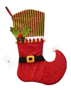 a red christmas stocking with a santa hat and holly on it's side