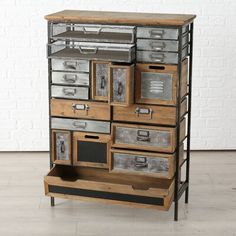 an old dresser with drawers and metal handles is shown in front of a white brick wall