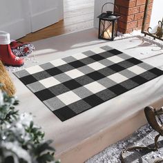 a black and white checkered rug sitting on top of a floor next to a fireplace