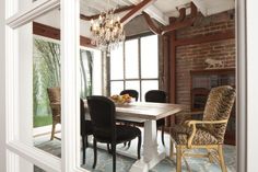 a dining room table with chairs and a chandelier hanging from it's ceiling