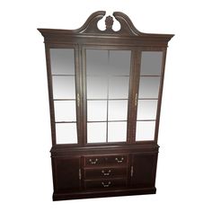 a wooden dresser with mirrored doors and drawers on the top shelf, in front of a white background