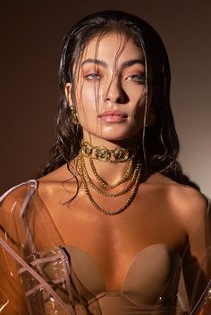 a woman with very large breast wearing gold jewelry