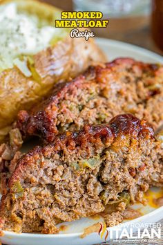 two meatloafs on a plate with sauce and bread in the back ground