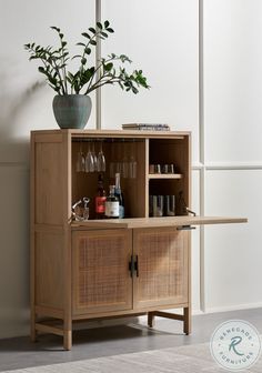 a wooden cabinet with two shelves and a plant in the corner on top of it