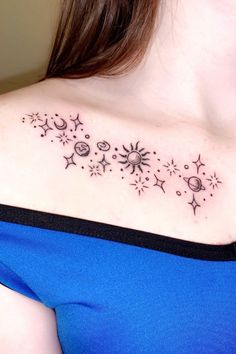 a woman's chest with stars and moon tattoos on her left shoulder, in black ink