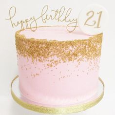 a pink and gold birthday cake with the number 21 on it