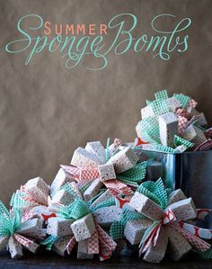 a pile of small bows sitting on top of a wooden table next to a can