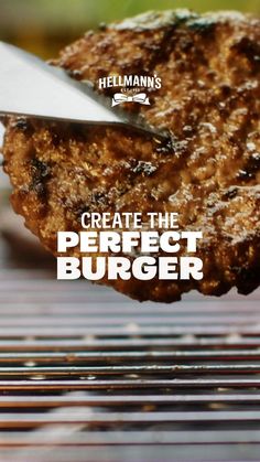 a hamburger being cut into pieces with a knife on top of it and the words hellman's create the perfect burger