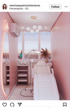 a white couch sitting in front of a window next to a desk with a lamp on it