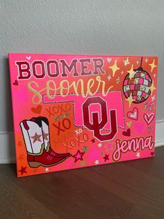 a sign that says boomer summer with boots and stars on the bottom, in front of a white wall