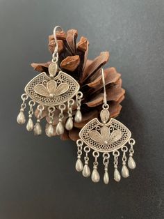 One Pair Hmong Silver Earrings,Vintage Earrings,Floral Design,Miao Silver ,Tribal Jewelry ,Boho Style. This earrings is handmade craft by our family lived in minority area Southwest of China. It's very unique. Also can bring you much luck. It's special workmanship. It can be a special gift. Width: 3cm Height:2cm Weight: 10g Care Instruction:  ❥. Avoid wearing the same miao silver jewelry for a long time.Take off your jewelry before bathing or swimming. ❥. Miao silver jewelry should avoid rubbing Vintage Pierced Jewelry For Festivals, Bohemian Drop Earrings For Vintage Collection, Bohemian Vintage Drop Earrings, Bohemian Sterling Silver Chandelier Earrings For Festivals, Bohemian Sterling Silver Drop Danglers, Handmade Antique Silver Vintage Earrings, Bohemian Sterling Silver Danglers, Handmade Vintage Antique Silver Earrings, Antique Jewelry For Pierced Ears