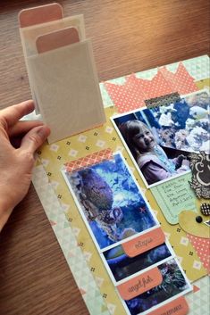 a person holding up a card with pictures on it and some cards in front of them