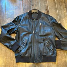 Men’s Real Leather Black Bomber Jacket. Size Large. With Rib Trim At Cuff Waist And Neckline. Nice Patterned Lining. Front Flap Pockets With Hidden Snap Closure. Also A Zip Chest Pocket And Hidden Inside Chest Pocket. Sleeve Length From Shoulder Seam Is 27”. Chest Measures 24.5” Flat From Armhole To Armhole. Length Is 26”. New Condition Blank Nyc, Chest Pocket, Flap Pocket, Mens Coats, Real Leather, Mens Jackets, Bomber Jacket, Jackets & Coats, Sleeve Length