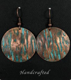 two round metal earrings with copper and turquoise paint