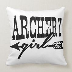 a pillow that says archery girl with an arrow on the front and black letters across it