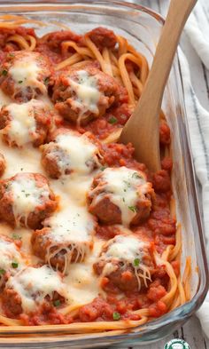 a glass casserole dish filled with meatballs and sauce, topped with parmesan cheese