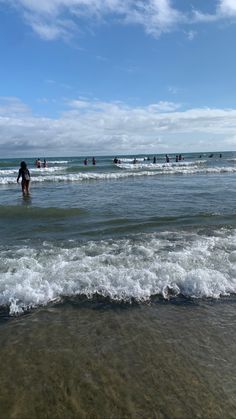 several people are in the water at the beach