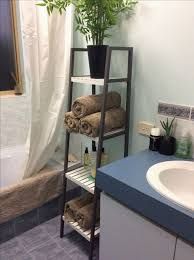 a bathroom with a sink, towel rack and toiletries on the shelf next to it