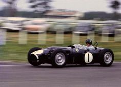 a man driving a race car on a track