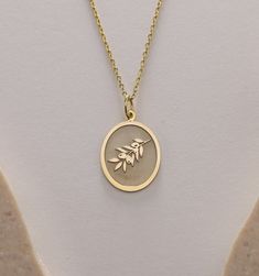 Gold Olive Tree Pendant - Olive Tree Branch Leaf Gold Necklace ● Material of pendant: Solid Gold 14k ( REAL GOLD ) ● Metal Stamp: 14k ( REAL GOLD ) ● The pendant is available in 5 sizes: - 12x17 mm / 0,47 x 0,66 inches - 13x18 mm / 0,51 x 0,70 inches  In the photos - 14x19 mm / 0,55 x 0,74 inches  - 16x21 mm / 0,62 x 0,82 inches  - 18x24 mm / 0,70 x 0,94 inches ( In the photos the size is 13x18 mm / 0,51 x 0,70 inches ) ( Jump Ring inner diameter: 4 mm ) ● Material of chain: Solid gold 14k ( REAL GOLD ) It is thin and dainty and it is available in 4 sizes: - 40 cm / 15,75 inches ( Length ) - 45 cm / 17,72 inches ( Length ) In the photos - 50 cm / 19,68 inches ( Length ) - 55 cm / 21,65 inches ( Length ) ● Backside engraving is FREE ( Please use the personalization box for that.) ● If you w 14k Gold Oval Pendant Charm Necklace For Gift, Oval Charm Necklaces As Gift, Oval Charm Necklaces For Gifts, Oval Charms Necklace For Gift, Anniversary Necklace With Oval Pendant And Charms, Oval Pendant Charm Necklace For Gift, Oval Gold Jewelry For Birthday, Yellow Gold Oval Charm Necklace As Gift, Yellow Gold Oval Charm Necklace Gift