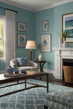 a living room filled with furniture and a fire place in front of a painting on the wall