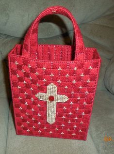 a small red bag with a cross on it