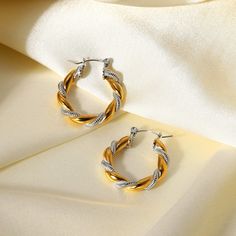 Elevate your style with the Two Tone Twisted Hoop Earrings, exquisitely handcrafted in 18k gold plating. These unique earrings feature an eye-catching twisted design in a two-tone finish, perfect for adding a modern twist to any look. Gold Twisted Metal Earrings, Modern Twist Gold-plated Hoop Earrings, Modern Twist Gold Plated Hoop Earrings, Gold Hoop Earrings With A Modern Twist, Gold Twisted Metal Hoop Earrings, Twisted Metal Earrings With A Modern Twist, Modern Twisted Metal Earrings, Modern Twisted Metal Hoop Earrings, Modern Twist Metal Hoop Earrings