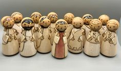 a group of wooden dolls standing next to each other