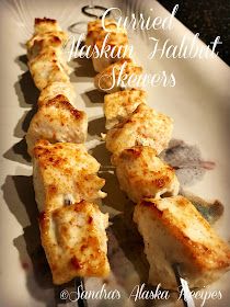 grilled alaskan halved scallops are served on a white platter