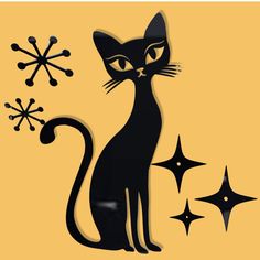 a black cat sitting next to snowflakes on a yellow background