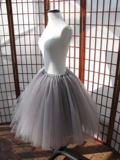 "This listing is for a custom version of the tulle skirt shown in the photos. There will be 8 layers of 100% nylon tulle with a full polyester satin lining. The waistband will be .75\" (2cm) wide elastic within a polyester satin casing. The skirt in the photos was made to fit a 28\" (71cm) waist and is 24\" (61cm) long. WAIST: Please select your waist from the listed ranges in inches or centimeters which will determine the price. LENGTH: Please let me know what length you need up to 25\" (64cm). Fitted Tulle Organza Skirt, Fitted Organza Tulle Skirt, Fitted Full Tulle Skirt Fabric, Fitted Tulle Petticoat Skirt, Fitted Tulle Tutu Dress With Tiered Skirt, Fitted Tiered Tulle Tutu Dress, Fitted Full Tulle Skirt, Stretch Tulle Petticoat Skirt, Fitted Tulle Pleated Skirt