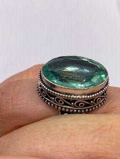 Large brilliant emerald green antique glass  Ornate German Silver  NOT 925  Vintage ring, does not tarnish Size 7.5 can be re sized, my jeweler charges a $20 fee All rings are shipped free in the US in a nice gift box.   Check out our over a THOUSAND great reviews Engraving is $4 per letter and is not always perfect depending on the piece. It can take a few days if the jeweler is busy. This is payable to Paypal Judithsltd@gmail.com Green Sterling Silver Topaz Ring, Antique Emerald Ring For Gift, Antique Emerald Ring As A Gift, Unique Faceted Green Jewelry, Green Oval Topaz Ring In Sterling Silver, Unique Green Faceted Jewelry, Antique Green Ring Gift, Antique Green Ring As Gift, Antique Green Rings For Gifts