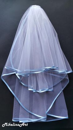 three tiered veils on top of each other with blue ribbon at the bottom