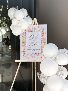 a sign with balloons attached to it in front of a door that says, baby is born