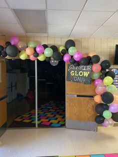 an entrance to a classroom decorated with balloons