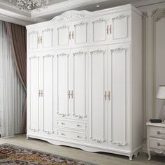 a large white armoire in a room with a chandelier and rug on the floor