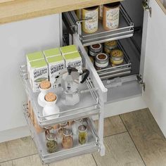 an open drawer in a kitchen with spices and condiments